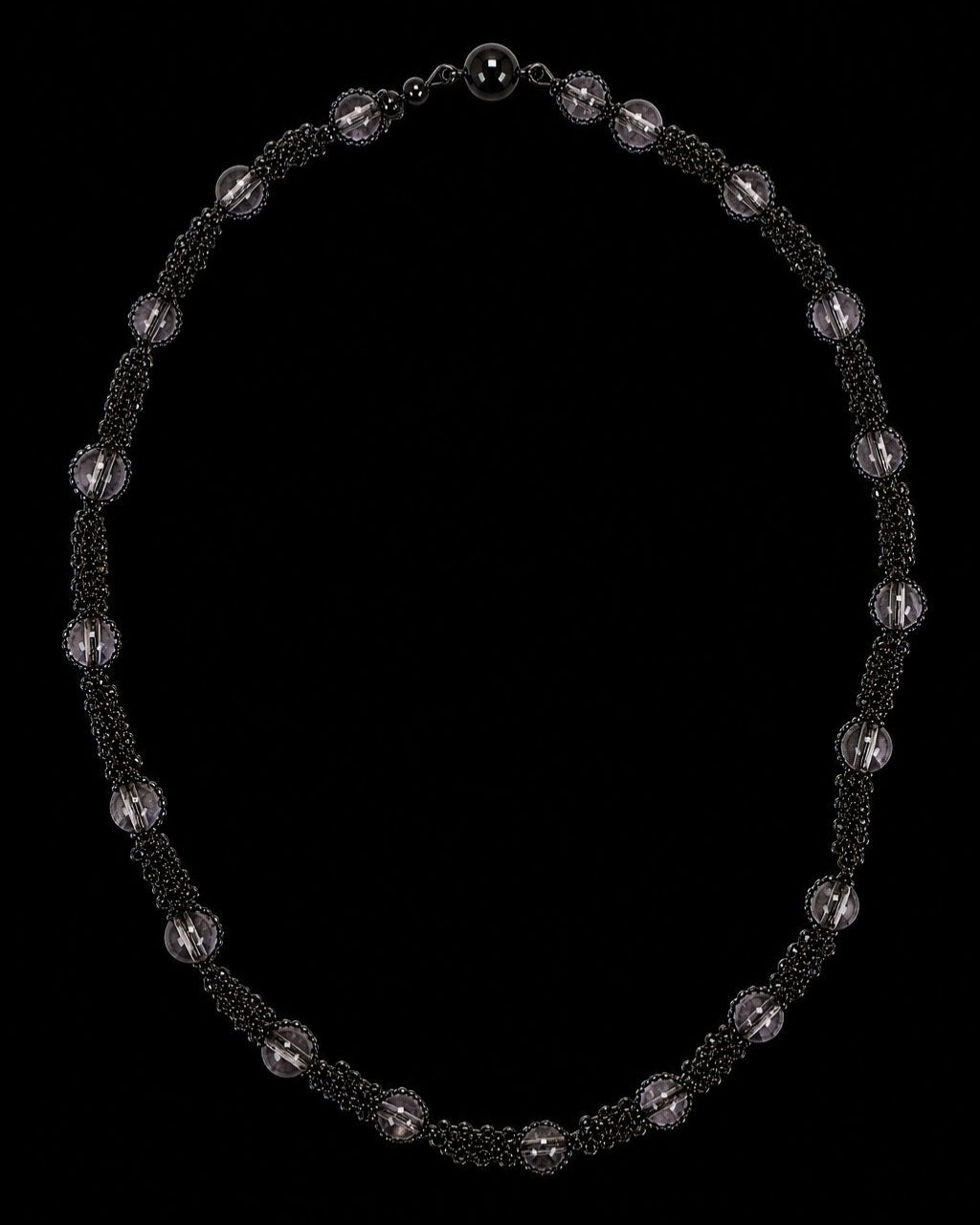 Black Smoky Bead Chain Necklace on a black background