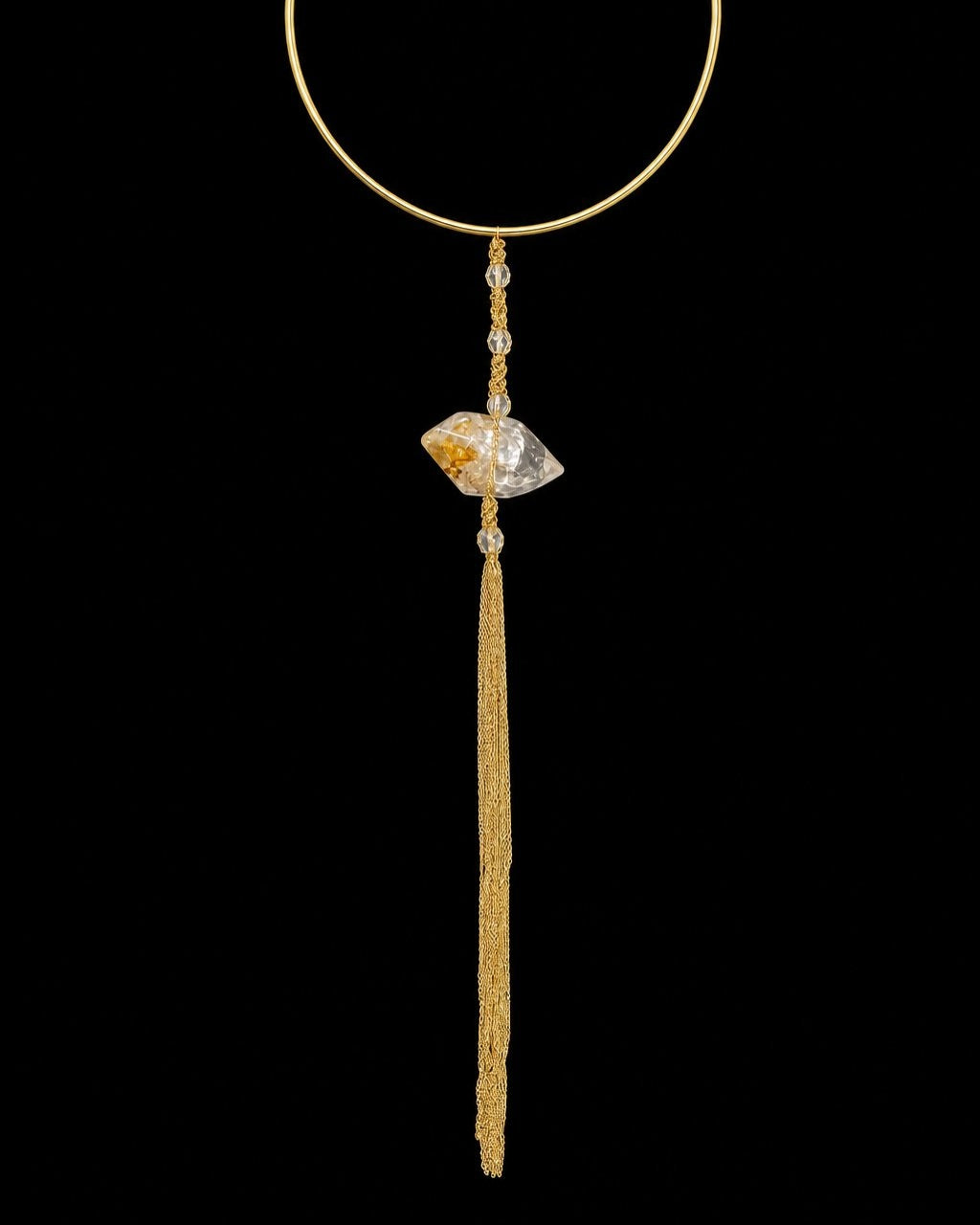 Gold Crystal Tassel Collar Necklace on a black background