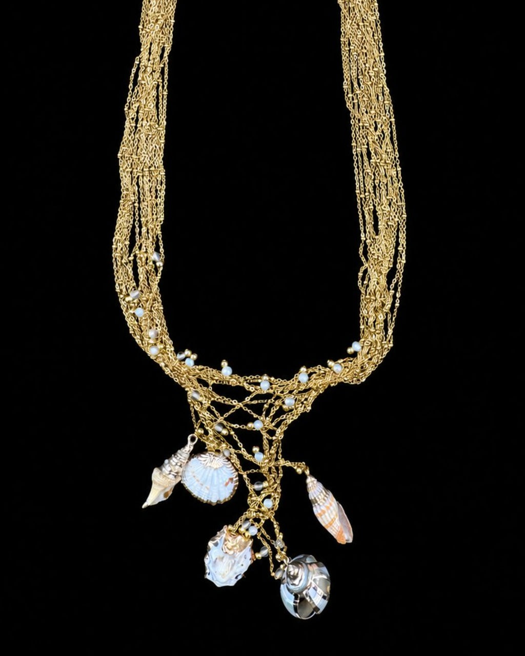 Gold Shell Charm Necklace on a black background