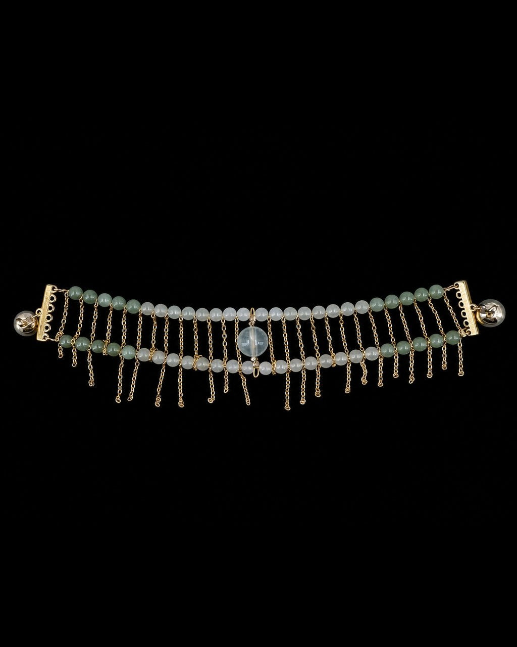 Green Bead Gold Chain Bracelet on a black background