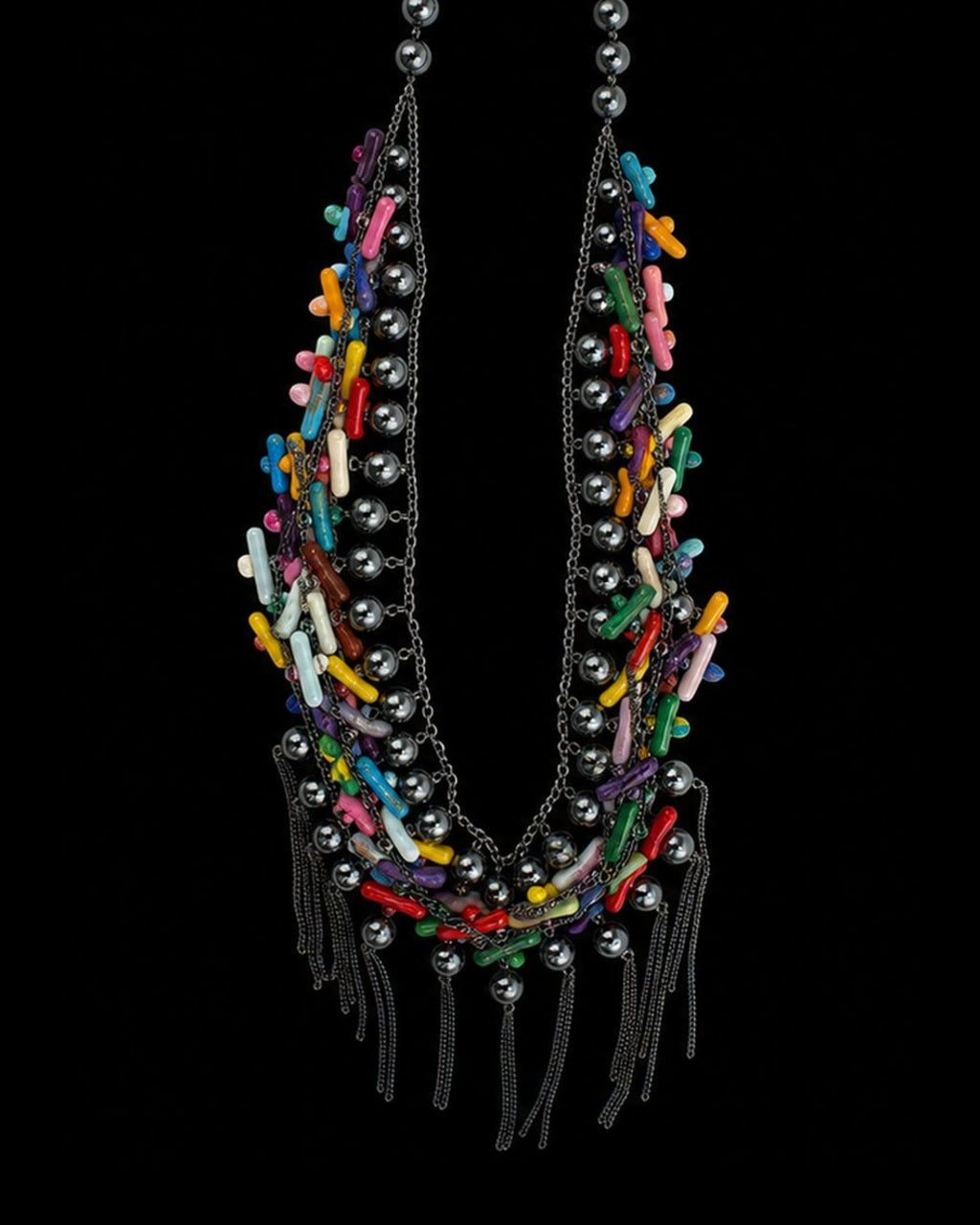 Multicolor Chip Gunmetal Tassel Necklace on a black background