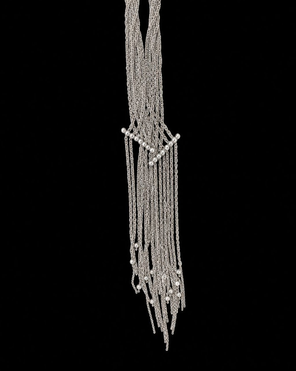Silver Chain Tassel Necklace on a black background
