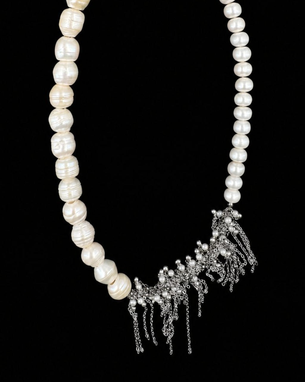 White Pearl Silver Tassel Necklace on a black background